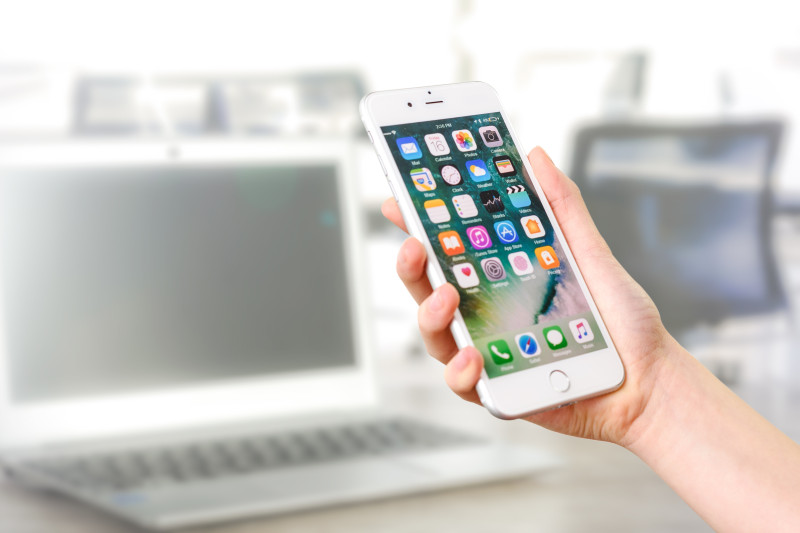 Person using mobile phone to check crypto prices